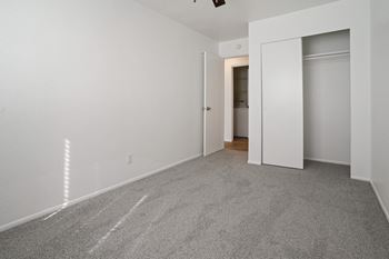 A room with white walls and a carpeted floor.